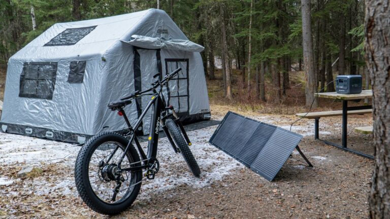Picture of a campsite and bike next to a solar panel